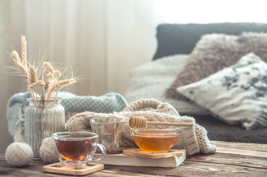 Still life details of home interior on a wooden table with a Cup of tea